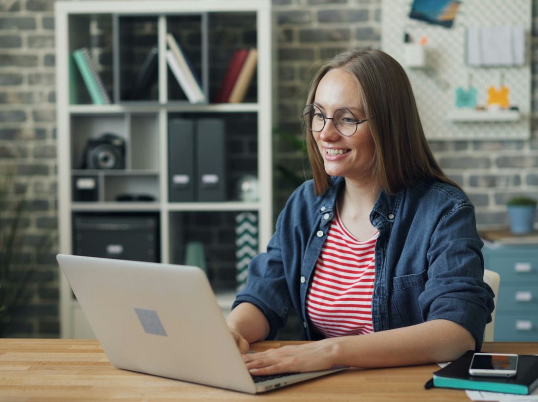 Client smiling during a video meeting on a laptop
